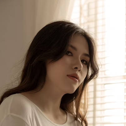 Woman in cream top indoors